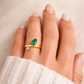 Gold pear-cut emerald ring on model hand, waterproof jewelry by XMTX Collections