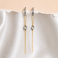 Kiana waterproof two tone chain drop earrings featuring silver hoops and gold chain details displayed on a soft neutral fabric backgrou