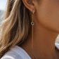 Model wearing Kiana waterproof mixed metal chain drop earrings with silver hoops and delicate gold chain accents