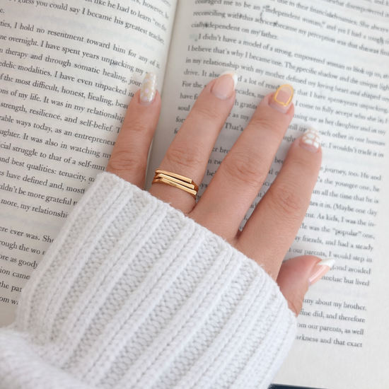 Lauren gold stacked ring worn on hand, everyday waterproof jewelry styled with cozy aesthetic