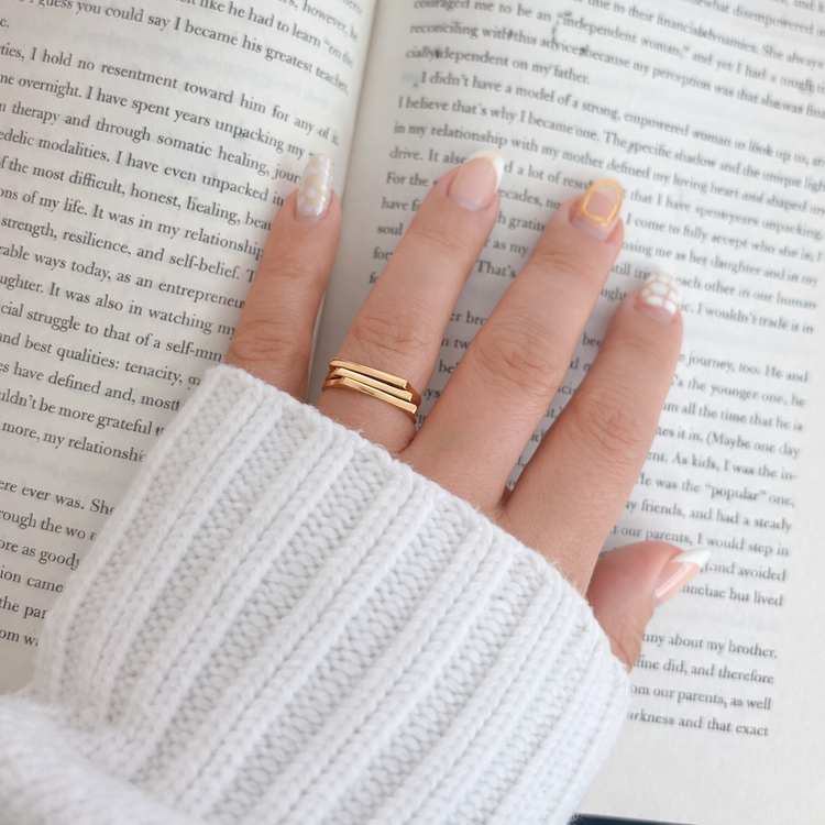 Lauren gold stacked ring worn on hand, everyday waterproof jewelry styled with cozy aesthetic