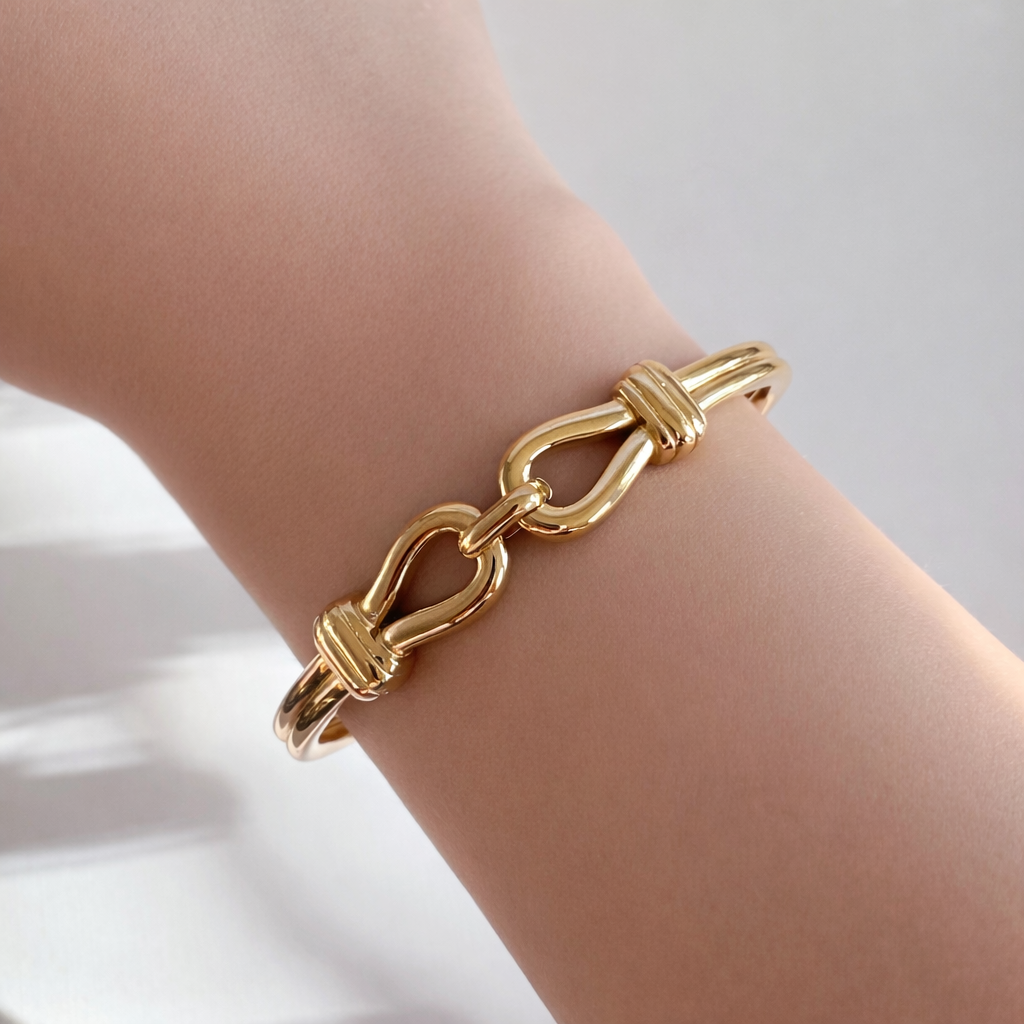 Gold interlock bangle bracelet worn on wrist – minimalist non-tarnish jewelry by XMTX Collections