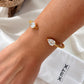 Lorena twisted gold bangle bracelet worn on wrist