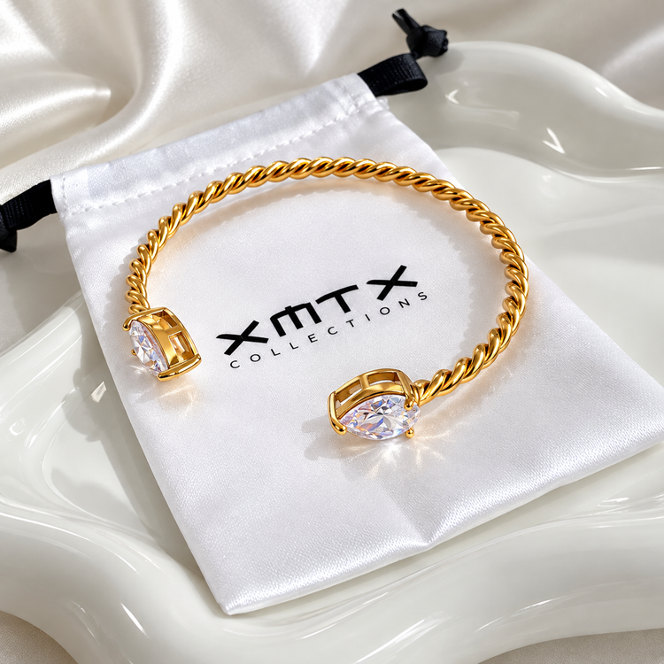 Gold Lorena waterproof bangle bracelet on XMTX jewelry pouch