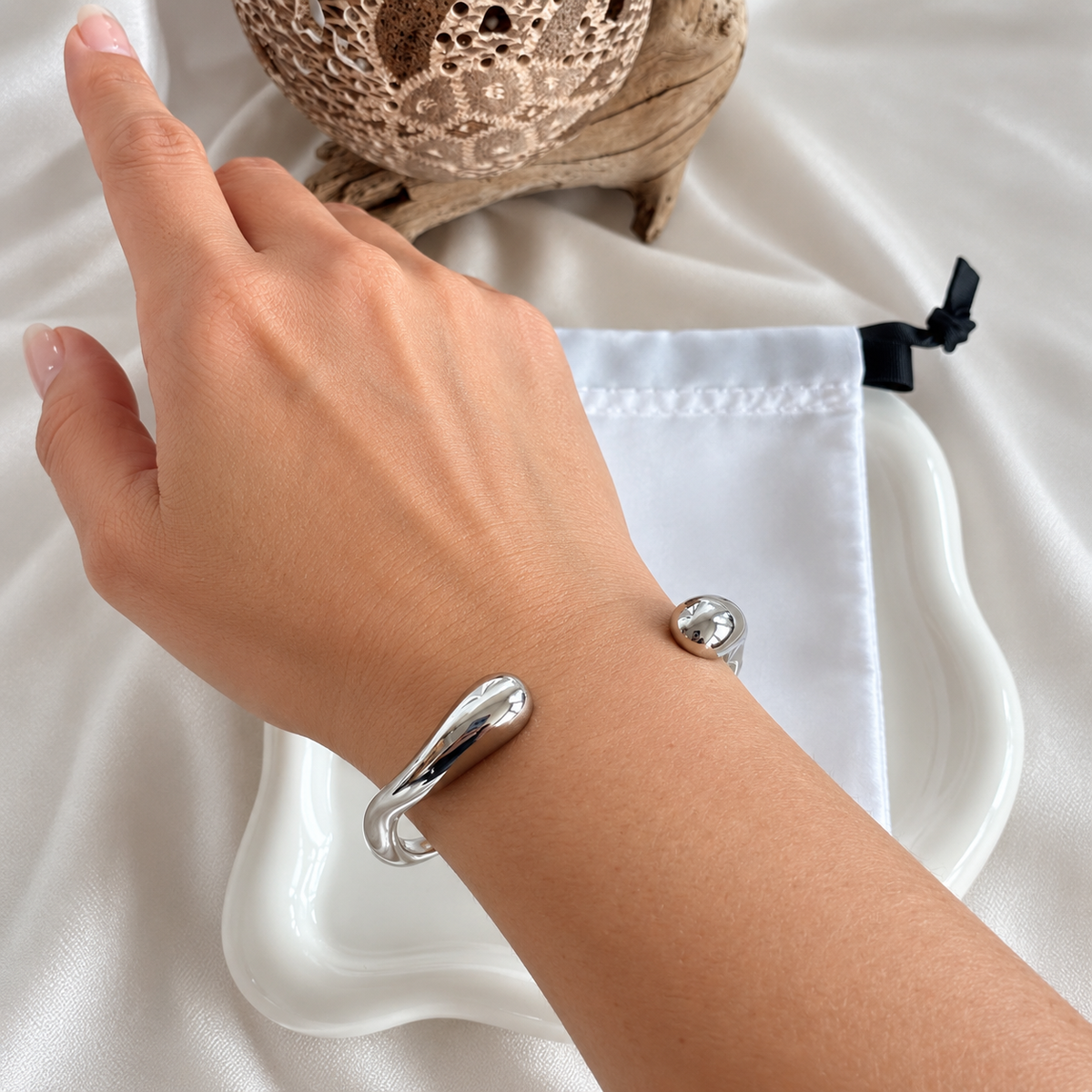 Lucia silver bangle bracelet worn on wrist