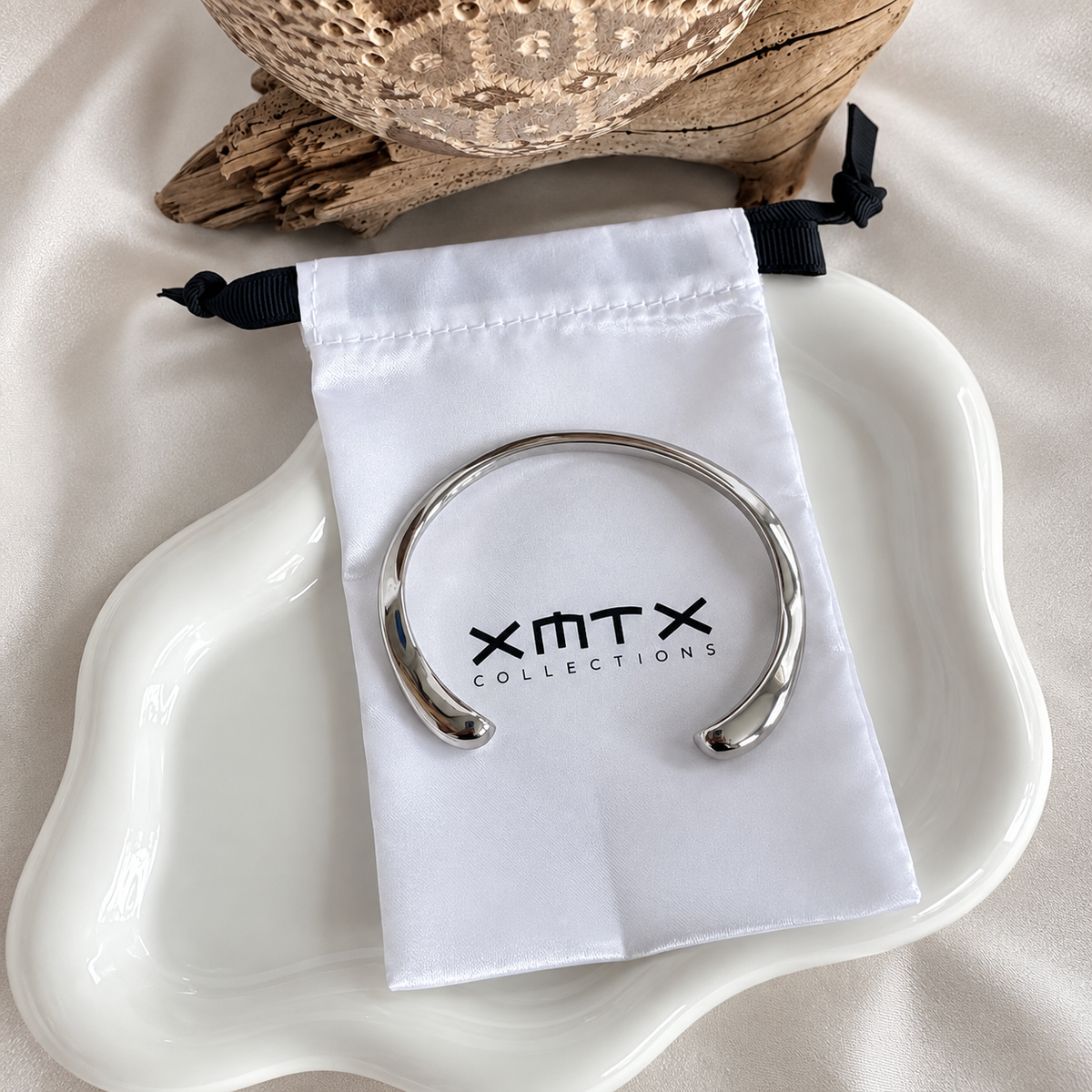 Lucia silver bangle bracelet with XMTX Collections pouch