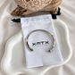 Lucia silver bangle bracelet with XMTX Collections pouch