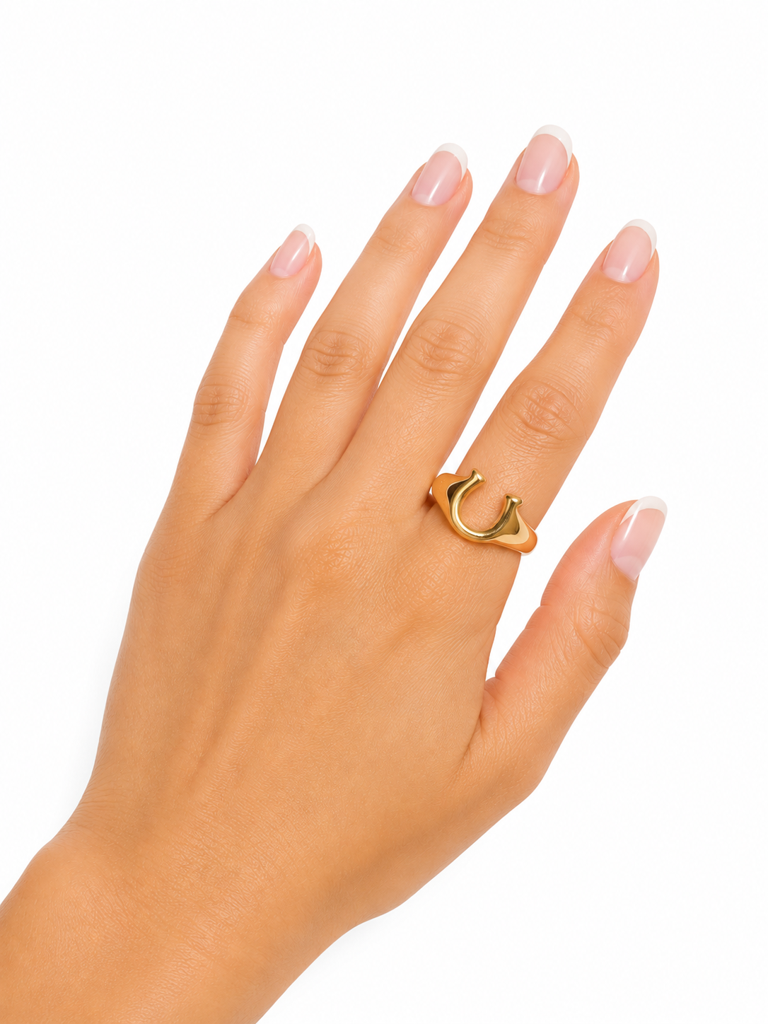 Model wearing the Lucky Horseshoe Ring, a waterproof non-tarnish gold statement ring with a polished horseshoe design.