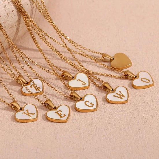 Personalized Mother of Pearl heart initial necklaces in 18K gold featuring genuine shell heart pendants, waterproof non-tarnish jewelry by XMTX Collections.