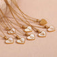 Personalized Mother of Pearl heart initial necklaces in 18K gold featuring genuine shell heart pendants, waterproof non-tarnish jewelry by XMTX Collections.