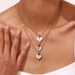 Mother of Pearl Heart Initial Necklace Model wearing a personalized Mother of Pearl heart initial necklace layered with other gold necklaces. Waterproof, non-tarnish everyday jewelry by XMTX Collections