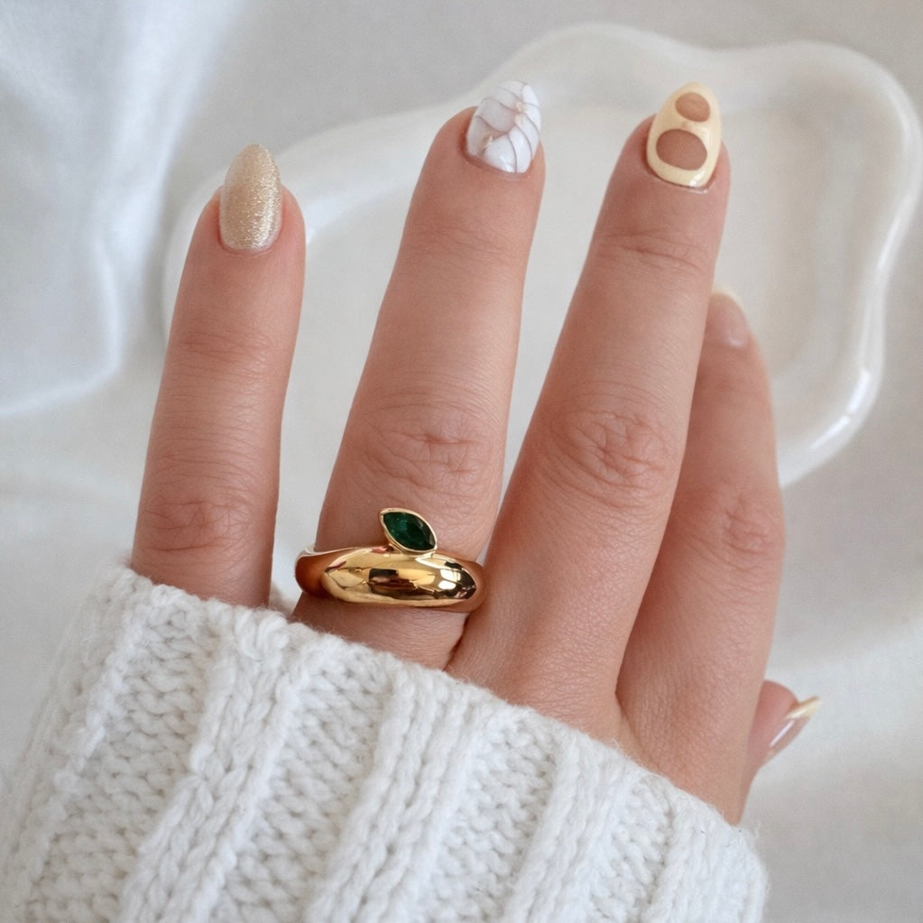 Natalie Ring gold dome band with emerald green marquise stone worn on hand