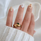 Natalie Ring gold dome band with emerald green marquise stone worn on hand