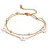 Add a touch of whimsy to your outfit with our Mother of Pearl Flowers Anklet. Delicate and dainty, this anklet features pretty, natural shell flowers that will elevate any look. Perfect for those who want to add a fun and playful touch to their style.

&nbsp;

This piece is made to last, hypoallergenic anti tarnish &amp; water resistant&nbsp;

316L Stainless Steel 18K Gold Plated

8.5 inches long +2 inches ext