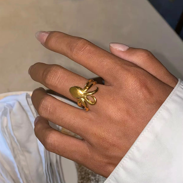 Experience beach life all year round with our Octopus Open Ring. This charming accessory is perfect for those who love forever summer vibes. Its cute design will add a touch of whimsy to any outfit. Get your hands on this must-have piece now.

Metal: 18K Gold over Stainless Steel&nbsp;

Size: Adjustable fits size 7/8