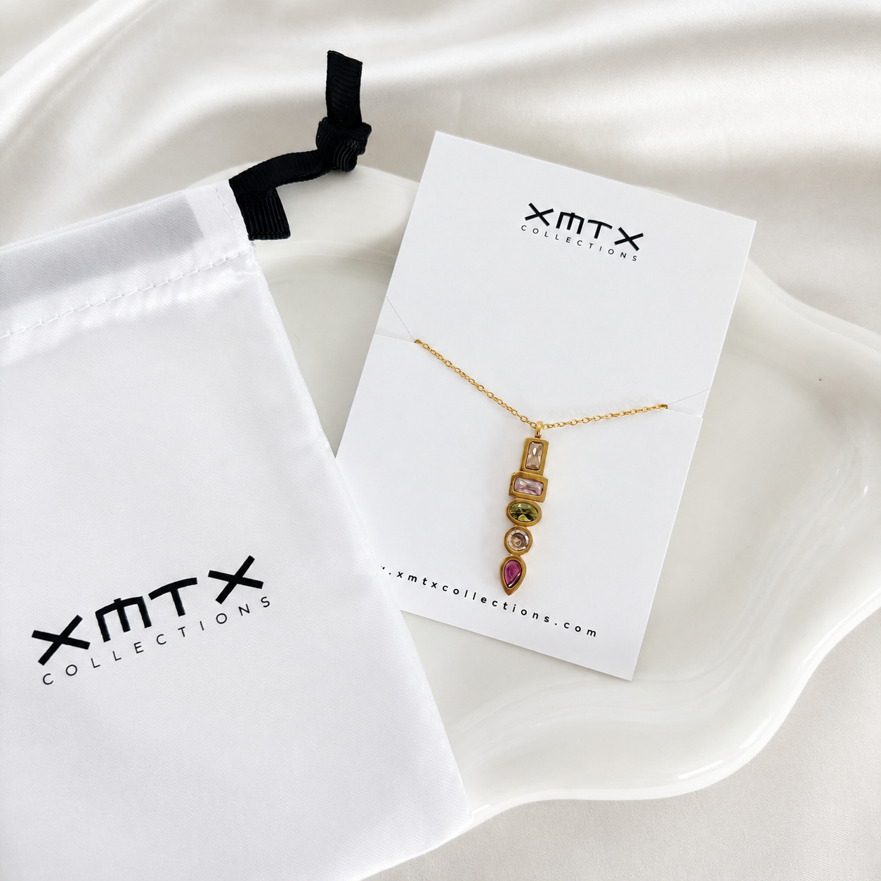 Waterproof non tarnish gold pendant necklace featuring five colorful bezel-set cubic zirconia stones.