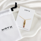 Waterproof non tarnish gold pendant necklace featuring five colorful bezel-set cubic zirconia stones.
