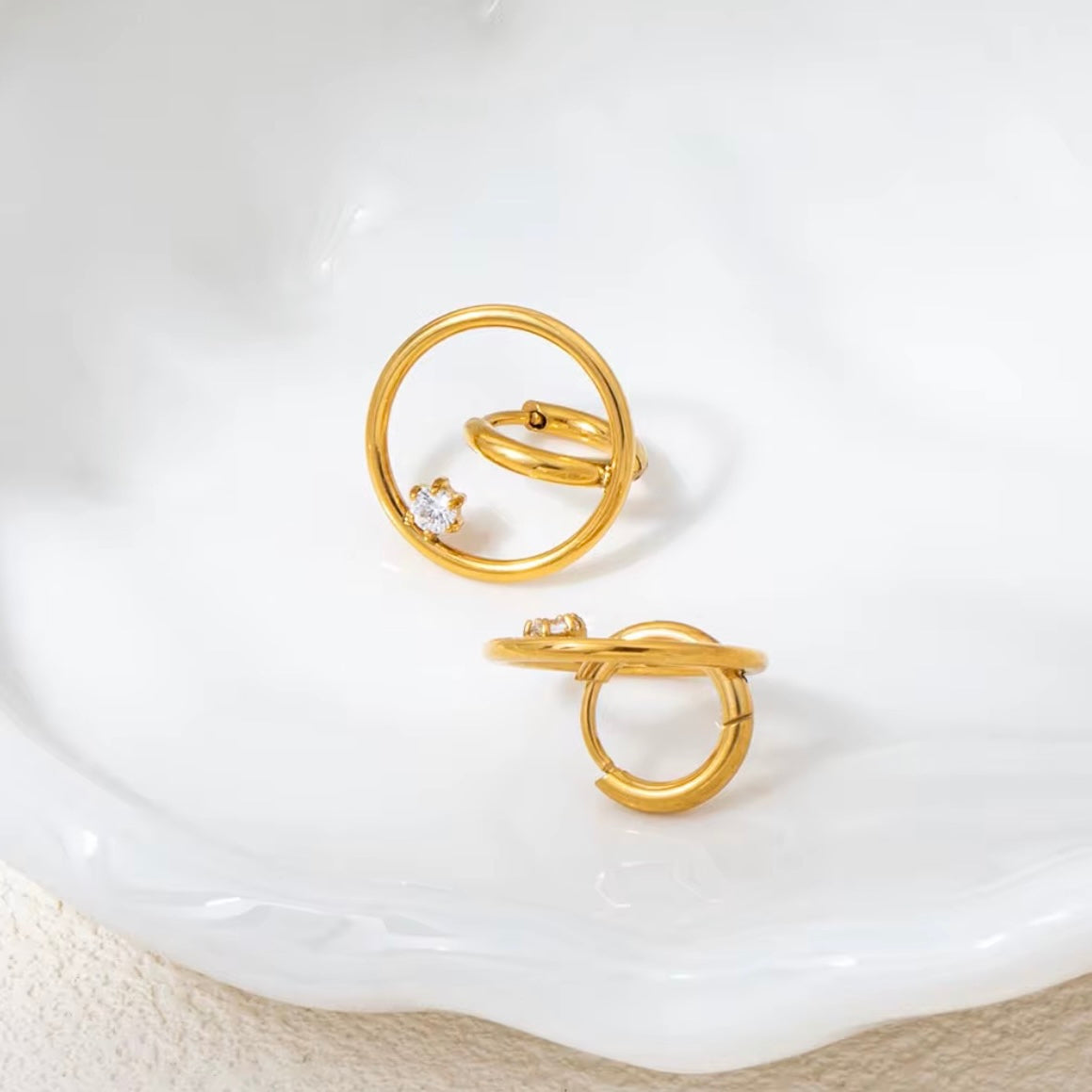 Close-up of Pyper waterproof gold earrings on ear