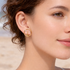 Model wearing Pyper gold circular earrings with stone detail