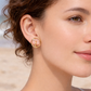 Model wearing Pyper gold circular earrings with stone detail