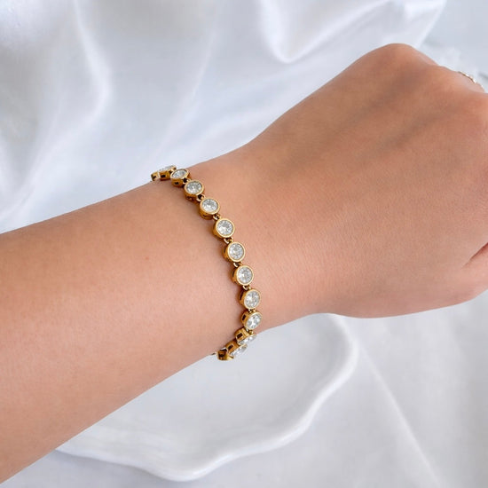 Gold Railey Rhinestone Bracelet with clear rhinestones worn on wrist against white background