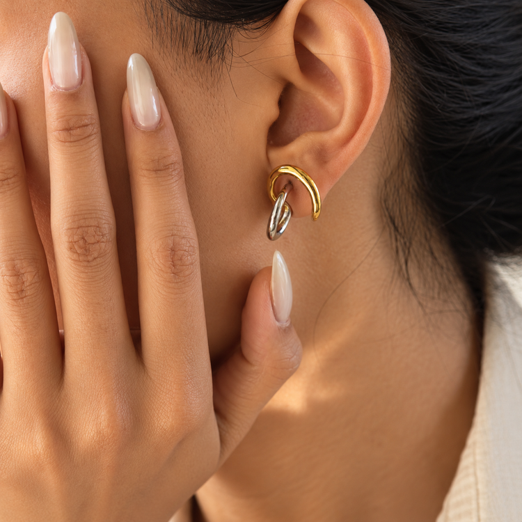 Rhea Lux two-tone hoop earrings worn on ear