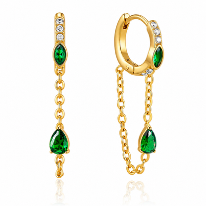 Waterproof gold huggie earrings with emerald green stones, cubic zirconia accents, and chain tassels.