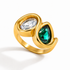Waterproof gold statement ring featuring a clear oval cubic zirconia and emerald green pear-cut stone.