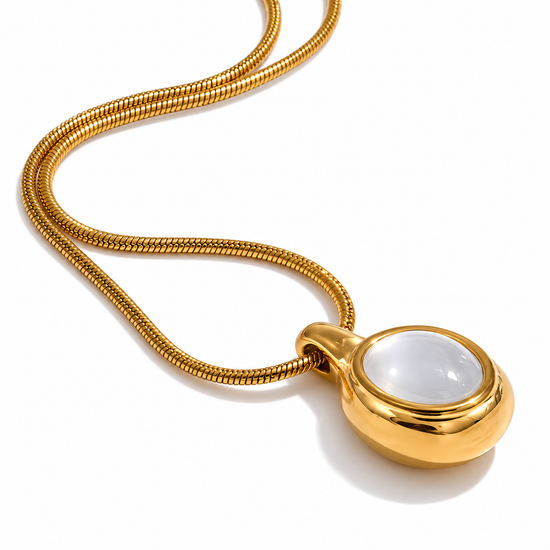 Close-up of Selena mother of pearl necklace with polished gold pendant and snake chain