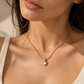 Selena gold mother of pearl pendant necklace worn on a model