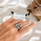 Silver knotted statement ring worn on hand