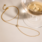 Single Flower Hand Chain with a cubic zirconia flower centerpiece styled in a luxury flat lay, showcasing waterproof, non-tarnish gold jewelry