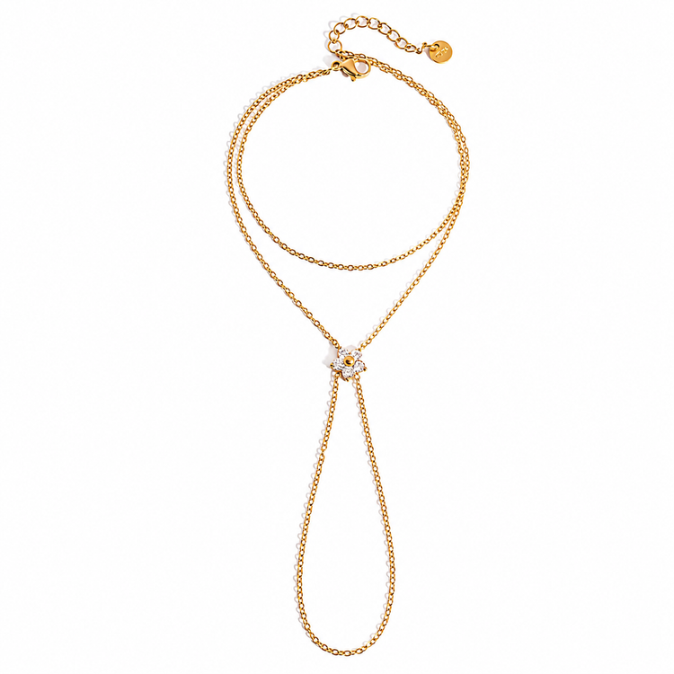 Single Flower Hand Chain featuring an adjustable bracelet and ring connected by a sparkling cubic zirconia flower crafted from 18K Gold PVD-plated stainless steel