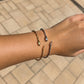 Gold and silver snake bangle bracelets worn together on the wrist, featuring waterproof non tarnish stainless steel 