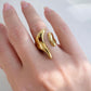 Gold open-end statement ring with organic molten design worn on hand, made of polished stainless steel, non-tarnish and waterproof by XMTX Collections