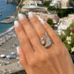 Close-up of the Soleil Melt Ring in silver worn on a model with white nails highlighting its contemporary sculptural design