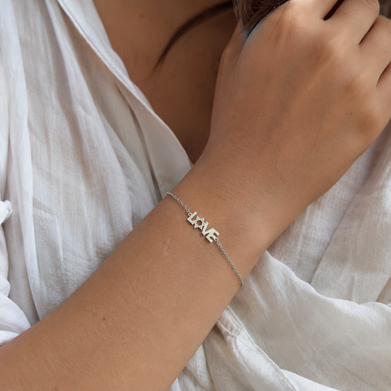 Woman wearing sterling silver LOVE Mogen David bracelet in natural lighting