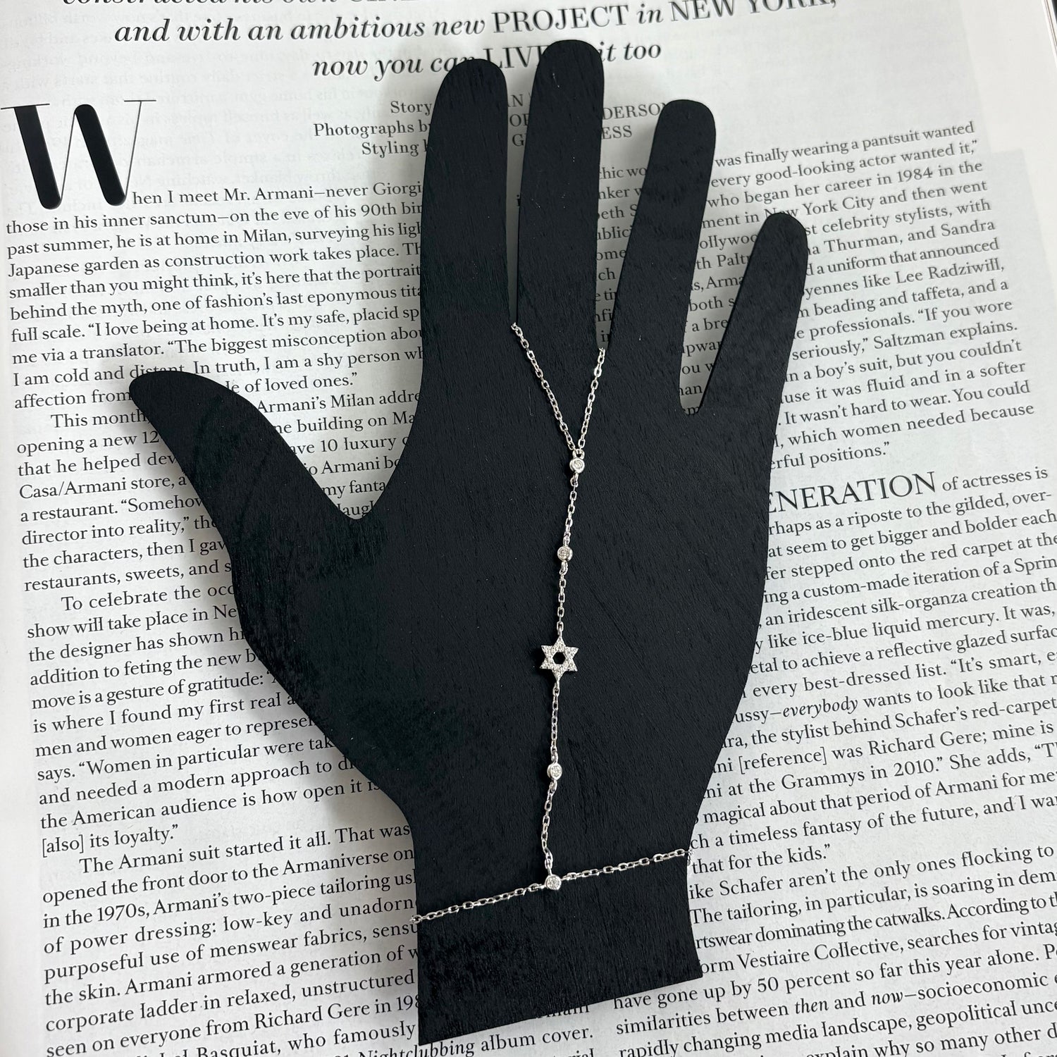 Sterling silver Star of David hand chain displayed on a jewelry hand stand highlighting its elegant adjustable design