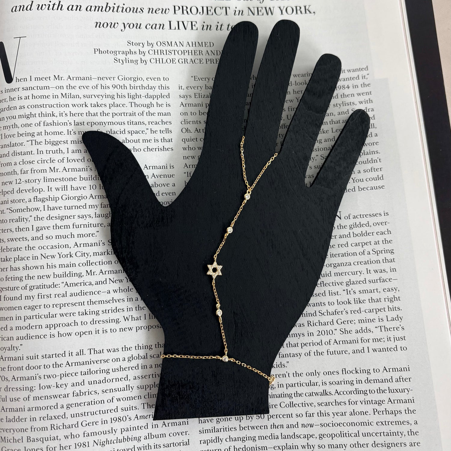 Sterling silver Star of David hand chain displayed on a jewelry hand stand with sparkling cubic zirconia accents.