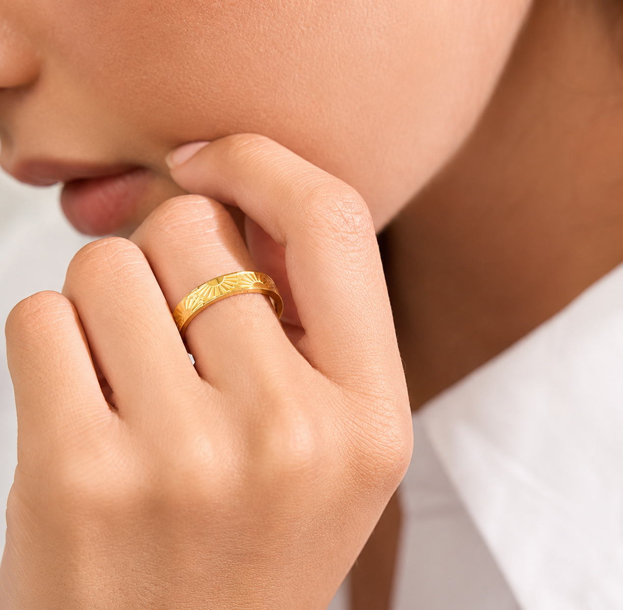Model wearing the waterproof Sun Ring featuring an engraved sunburst design