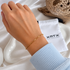 Tillie Dainty Bracelet worn on the wrist, featuring a delicate gold mixed-link design