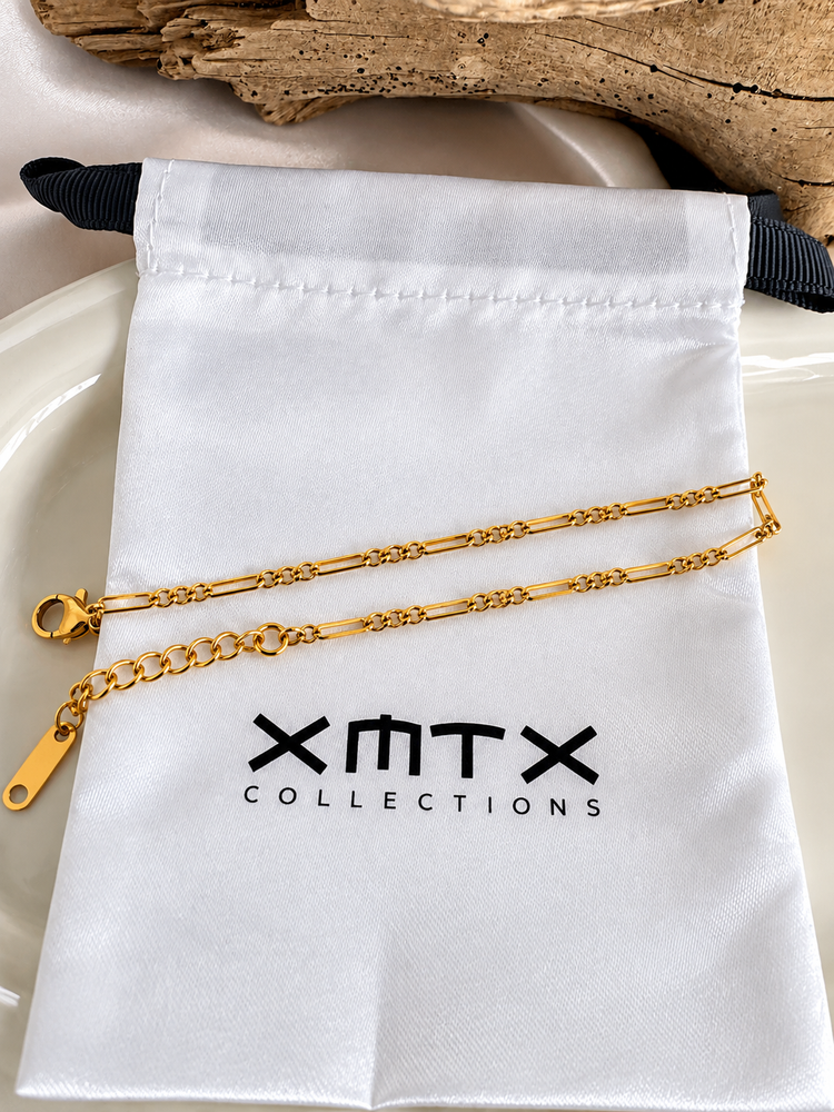 TTillie Dainty Bracelet styled on an XMTX Collections jewelry pouch, featuring a waterproof non-tarnish gold chain