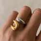 Model wearing the Two Tone Open Ring featuring a polished mixed gold and silver design