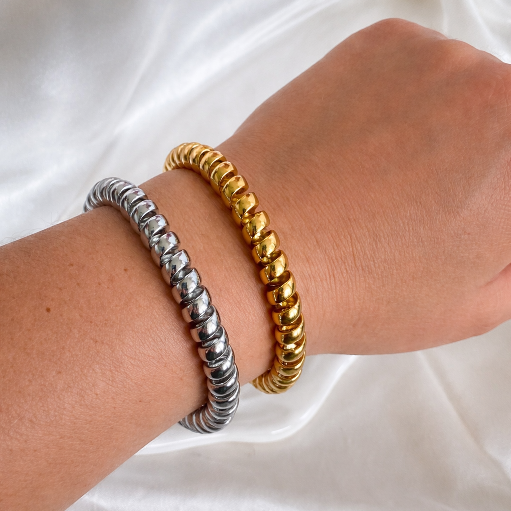 Gold and silver Vintage Phone Cord Bangle Bracelets worn on a wrist