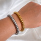 Gold and silver Vintage Phone Cord Bangle Bracelets worn on a wrist