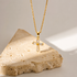 Vintage rhinestone cross necklace in 18K gold PVD plated stainless steel featuring baguette-cut rhinestones and a waterproof, non-tarnish finish.