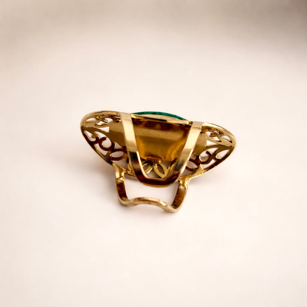 Back view of gold ring showing adjustable band and design detail
