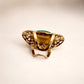 Back view of gold ring showing adjustable band and design detail