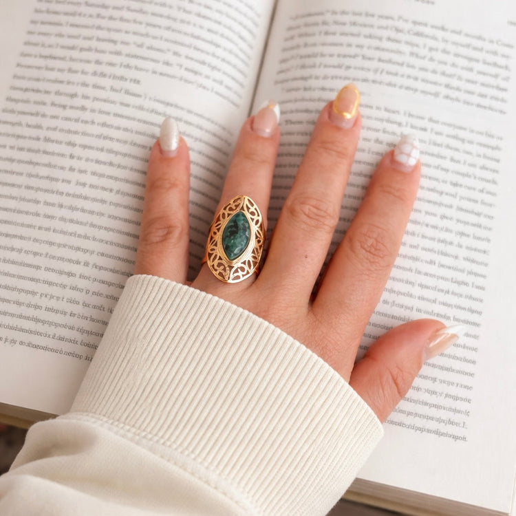 Woman wearing African turquoise gold ring on hand lifestyle shot