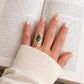 Woman wearing African turquoise gold ring on hand lifestyle shot